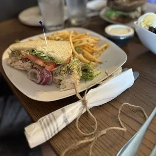 Half of the Chicken Avocado Bacon sandwich and Truffle fries.