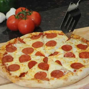 a pepperoni pizza on a cutting board