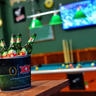 a bucket of beer and pool tables