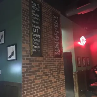 a brick wall with a menu on it