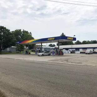 a gas station with cars parked in front of it