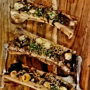 a wooden cutting board with a knife and fork