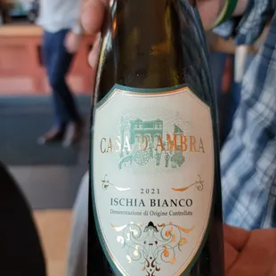 a person holding a bottle of wine