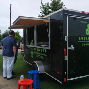 a man standing in front of a food truck