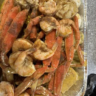 a container of crab legs and shrimp