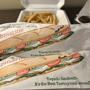 two sub sandwiches and french fries