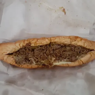 Philly cheesesteak with grilled onion, pickles and provolone cheese.