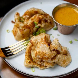Roti Prata-
Traditional Indian Flatbread,
Scallions, In-house Yellow Coconut Curry Dip