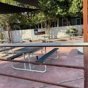 a picnic area with tables and umbrellas