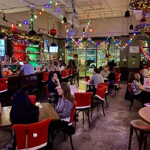 people sitting at tables in a restaurant