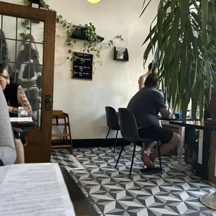 people sitting at tables in a cafe