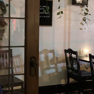 a woman sitting at a table with a glass of wine