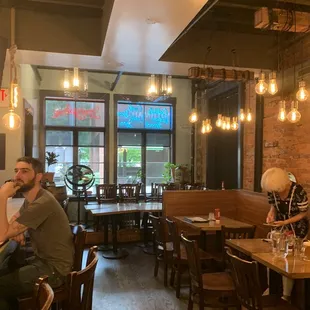 people sitting at tables in a restaurant