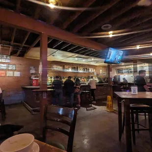 people sitting at tables in a restaurant