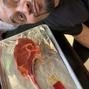 a man with a knife and a piece of meat