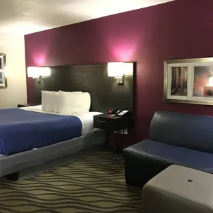 King Size Bed. Crisp clean linens. Lamps and USB ports nearby. Small couch to relax on.