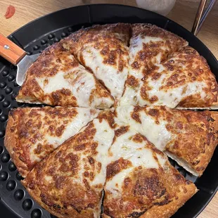 Thick crust cheese pizza with red and pesto sauce