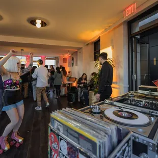 a group of people standing around a record player