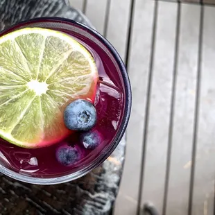 a blueberry and lime drink on a table