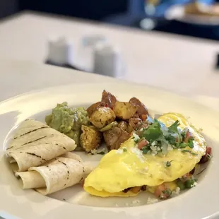 Veggie omelette with breakfast potatoes and a dollop of Guac