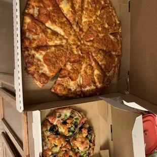 Large pepperoni pizza and personal veggie pizza.