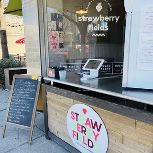 Service counter - interior is not open, there is a small seating area outdoors to the left.