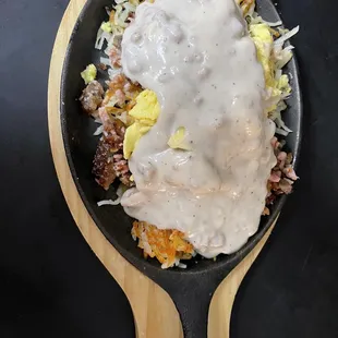 a skillet of food with gravy