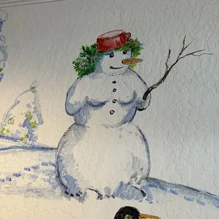 Female snow sculpture mural in hallway over their microwave.