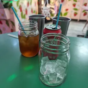 two jars of iced tea and a can of soda