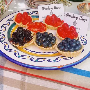 Fruit tarlets with pastry cream, chocolate mousse, or lemon curd fillings.