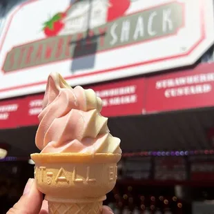 a hand holding an ice cream cone