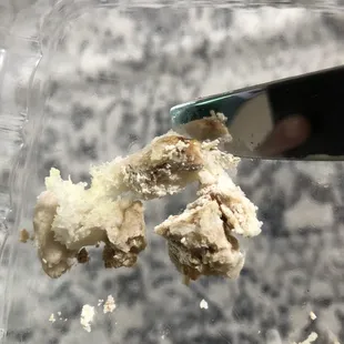 a person cutting a piece of cake