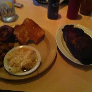Porksteak with fried okra, onion rings and scalloped potatos