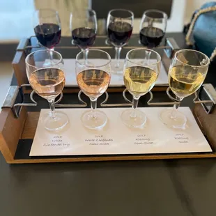 five glasses of wine on a tray