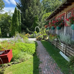 a brick pathway leading to a garden
