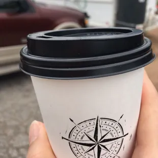 a hand holding a cup of coffee