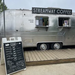 a coffee truck parked on a sidewalk