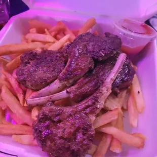 a tray of meat and french fries