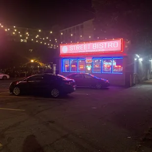 cars parked in a parking lot at night