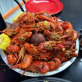 a plate of crawfish and corn