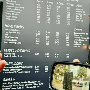 a person taking a picture of the menu