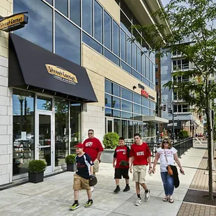 people walking down the sidewalk