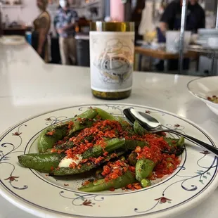 a plate of peppers and a bottle of wine