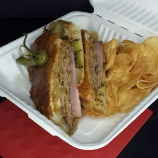 Cubano sandwich and chips. Plenty o' filling in that filling sandwich.