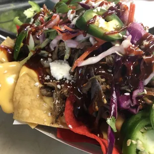 BBQ-Chipotle Pulled Pork Nachos w/ chili con Queso, cilantro-Asian slaw , fresh jalepenos, and queso fresco