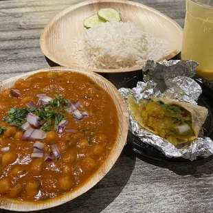 Channa Masala Curry (chickpeas cooked in onion tomato masala gravy) with side of rice and cucumber. Aloo Masala Roll (spicy)! Mango Lassi.