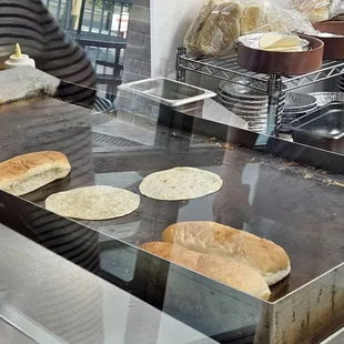 Heating the tortillas (flour or corn) and hot do buns