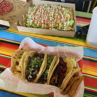 Shrimp taco, Barbacoa taco, steak taco and cochinita taco with pickled red onions.