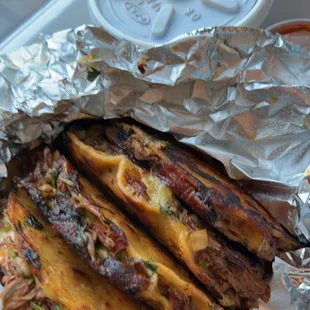 a tray of street tacos on a table