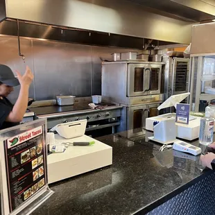 a man and a woman in a restaurant kitchen